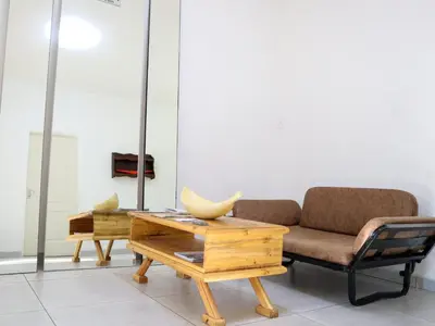 a living room with a couch and a table at Casa Palmeira in Nelspruit