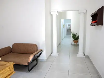 a living room with a couch and a hallway at Casa Palmeira in Nelspruit