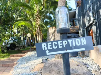a street sign on a light pole in front of a house at Casa Palmeira in Nelspruit
