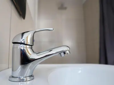 a bathroom sink with a chrome faucet at Casa Palmeira in Nelspruit