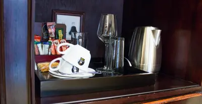 a counter top with a plate and a wine glass at Candlewoods Guesthouse in Centurion