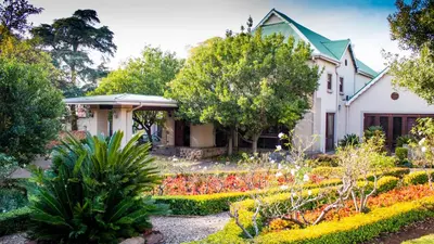 a house with a garden in front of it at Candlewoods Guesthouse in Centurion
