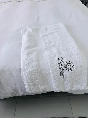 a close up of a white blanket on a bed at Zindiza Guesthouse in Witbank