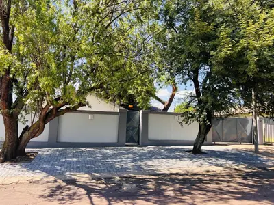 a white garage with trees in front of it at Zindiza Guesthouse in Witbank