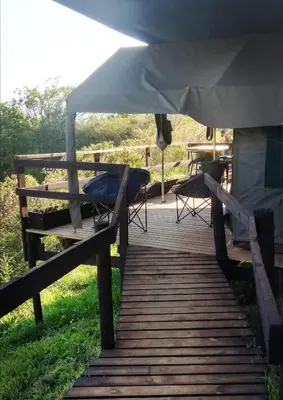 a wooden boardwalk with a tent on top of it at Chosen Glamping Tents in Graskop