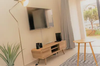 a living room with a tv on a wall at Ground Floor Apartment Midrand in Midrand