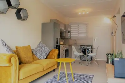 a living room with a couch and a table at Ground Floor Apartment Midrand in Midrand