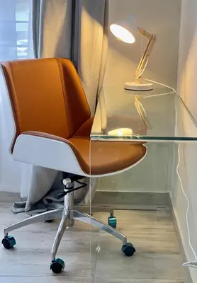 a glass desk with a chair and a lamp at Ground Floor Apartment Midrand in Midrand
