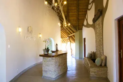 a hallway with a stone counter in a building at Kambaku River Sands in Timbavati Game Reserve