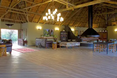 a large living room with furniture and a large ceiling at Kambaku River Sands in Timbavati Game Reserve