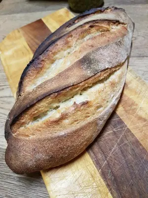 a loaf of bread sitting on a cutting board at Stoep Cafe Guest House in Komatipoort