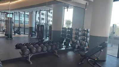 a gym with rows of exercise equipment in a building at Modern 1 Bedroom Executive Apartment in Waterfall in Midrand
