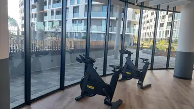 a gym with tread machines in front of a building at Modern 1 Bedroom Executive Apartment in Waterfall in Midrand