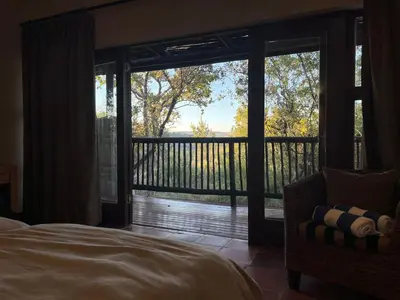 a bedroom with a bed and a large sliding glass door at Elements Private Golf Reserve Unit 149 or 150 in Bela-Bela