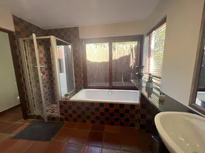 a bathroom with a tub and a sink at Elements Private Golf Reserve Unit 149 or 150 in Bela-Bela