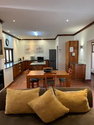 a living room and kitchen with a couch and a table at Elements Private Golf Reserve Unit 149 or 150 in Bela-Bela