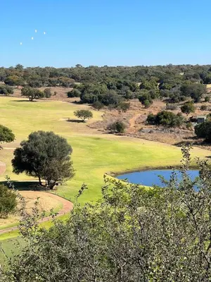 an aerial view of a golf course with a pond at Elements Private Golf Reserve Unit 149 or 150 in Bela-Bela