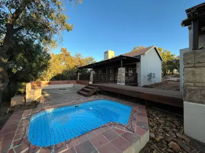 a swimming pool in a yard next to a house at Elements Private Golf Reserve Unit 149 or 150 in Bela-Bela