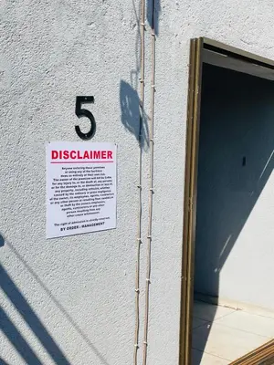 a sign on the side of a building with the number at Zinathi Lodge in Lebowakgomo