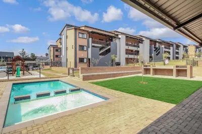 an image of a swimming pool in front of a building at Smartz Apartment 334 in Midrand