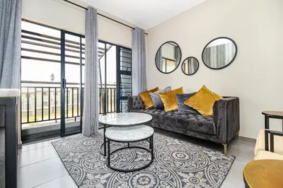 a living room with a couch and a table at Smartz Apartment 334 in Midrand