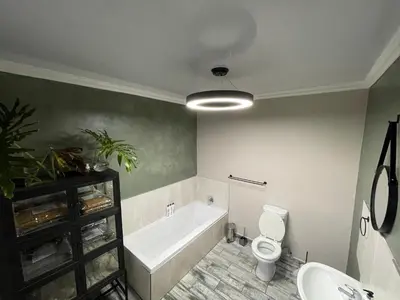 a bathroom with a tub and a toilet and a sink at Langalanga on the mountain bend in Tzaneen