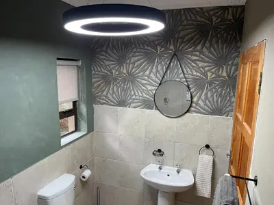 a bathroom with a sink and a mirror at Langalanga on the mountain bend in Tzaneen