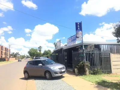 a silver car parked on the side of a street at Mighty7 Guesthouse in Pretoria