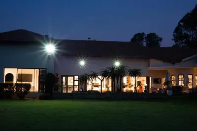 a house lit up at night with lights at Luxury Boutique Home in Kyalami in Midrand