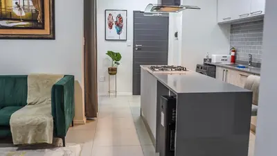 a kitchen with a counter and a stove top oven at Fumo House Lifestyle Apartments in Midrand