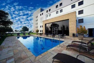 a swimming pool in front of a building at The RidgePoint Hotel in Witbank