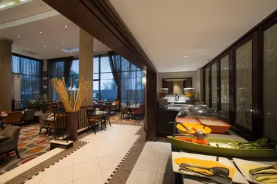 a hotel room with a lobby with tables and chairs at The RidgePoint Hotel in Witbank