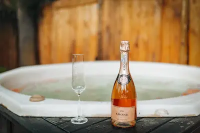 a bottle of champagne and a glass in a tub at The Bliss Boutique in Louis Trichardt