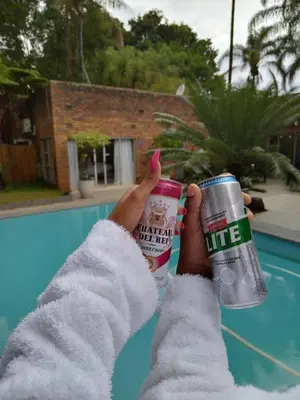 a person is holding up two cups of coffee at The Bliss Boutique in Louis Trichardt