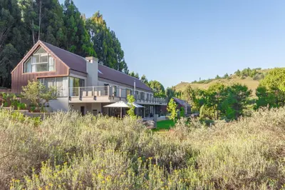 a house on the side of a hill at Misty Meadows in Dullstroom