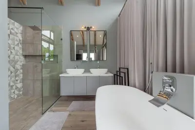 a bathroom with two sinks and a mirror at Misty Meadows in Dullstroom