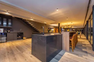 an open kitchen and dining room with a staircase at Misty Meadows in Dullstroom