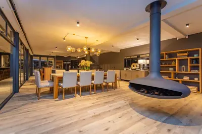 a kitchen and dining room with a fireplace in a house at Misty Meadows in Dullstroom