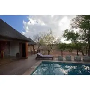 a swimming pool in front of a house at Mount Marula Game Lodge - Tambotie in Kwarriekraal