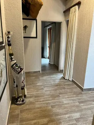 a hallway with a tiled floor in a house at Dreamy 3 bedroom villa on the edge of the Sabie River in Kruger Park Lodge in Hazyview