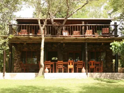 a wooden house with a balcony on top of it at Zazu Private Bush Lodge, Formerly Masodini in Hoedspruit