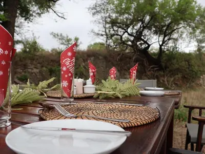 a wooden table with a plate on top at Zazu Private Bush Lodge, Formerly Masodini in Hoedspruit