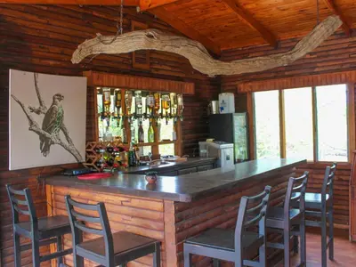 a bar in a cabin with chairs around it at Zazu Private Bush Lodge, Formerly Masodini in Hoedspruit