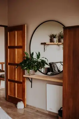 a room with a mirror and a shelf with plants at Sorgenfri in Hendrina