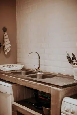 a kitchen with a sink and a counter top at Sorgenfri in Hendrina