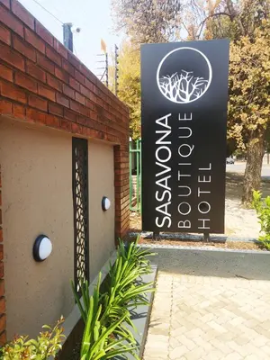 a sign on the side of a brick building at Sasavona Boutique Hotel in Polokwane