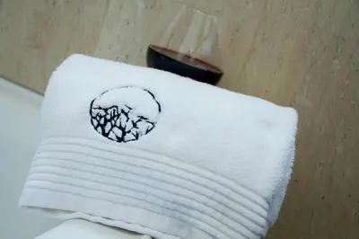 a white towel with a drawing on it at Sasavona Boutique Hotel in Polokwane
