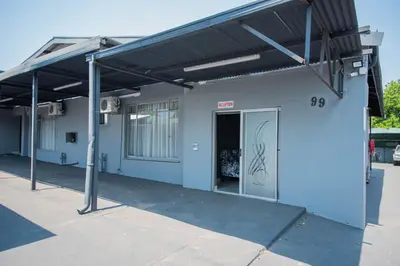 a building with awning on the side of it at President Guest Lodge in Louis Trichardt