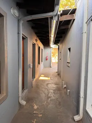an empty hallway of a building with an alley way at President Guest Lodge in Louis Trichardt
