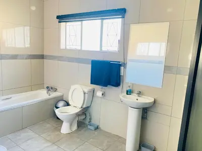 a bathroom with a toilet and a sink at President Guest Lodge in Louis Trichardt